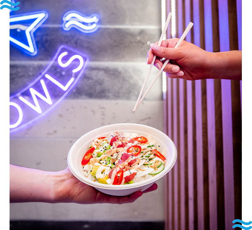 hand with chopsticks grabbing at a bowl